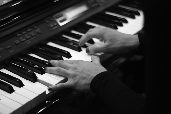 fingers on piano keys